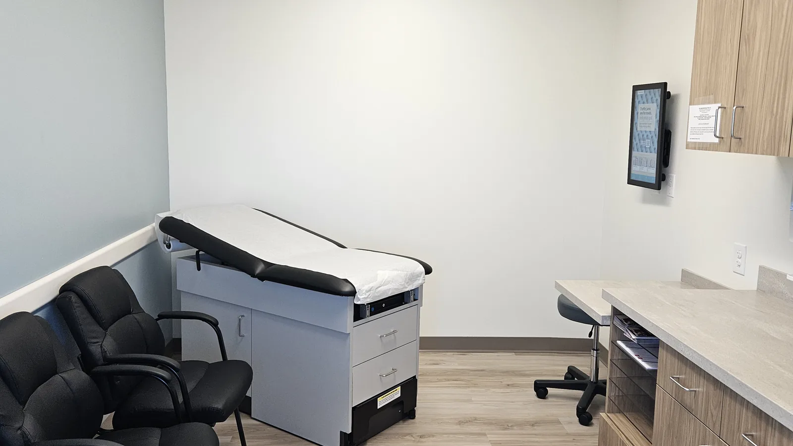 An exam room at our Akron office, with an exam table and seating for family