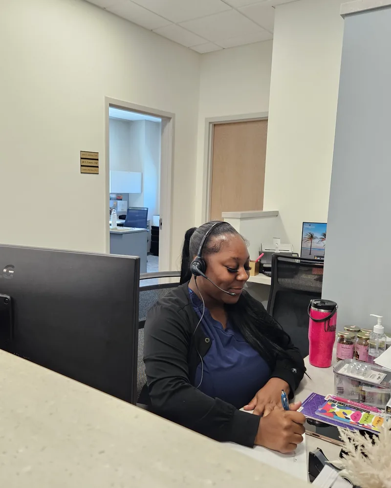 A member of the front-desk team taking a call at our Akron office